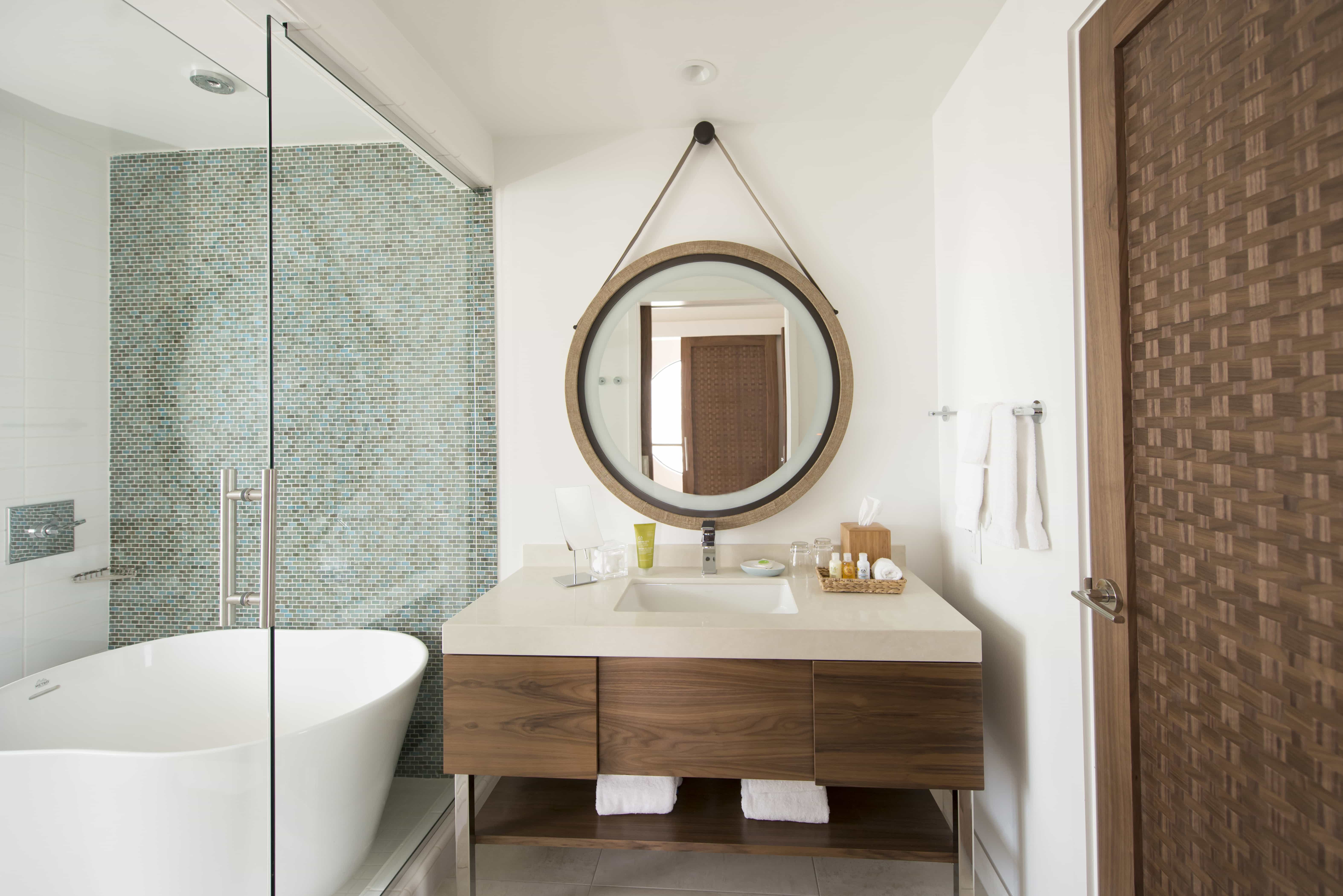 Luxury hospitality bathroom with brass-trimmed shower enclosure
